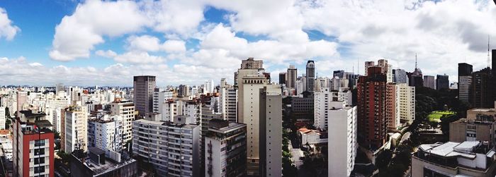 Buildings against cloudy sky