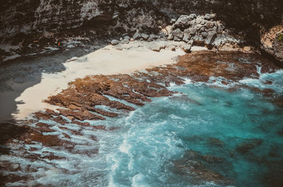 High angle view of water flowing over sea