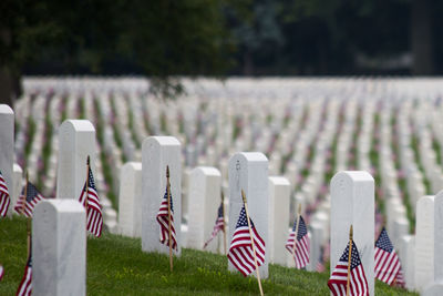 Close-up of flags against the sky at cemetery