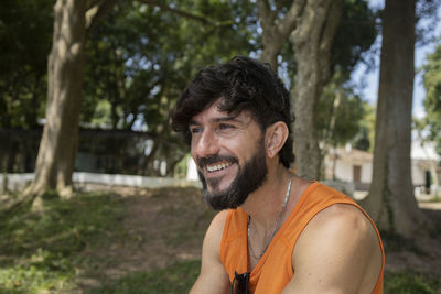 Man at a park on a beautiful sunny day with laptop. notebook work and leisure. green and nature