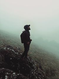 Full length of man standing on landscape against sky