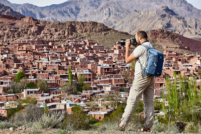 Full length of photographer photographing buildings