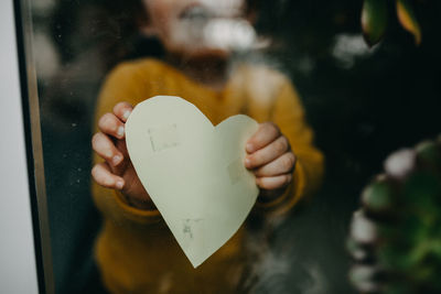 Close-up of hand holding heart shape