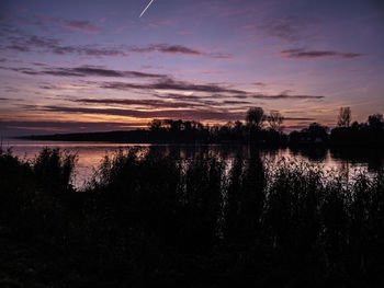 Scenic view of lake at sunset