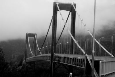 View of suspension bridge in foggy weather