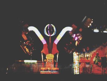 Low angle view of illuminated ferris wheel
