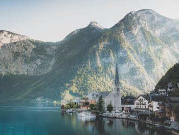 Scenic view of lake by town against sky