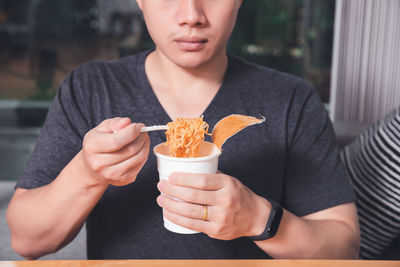 Midsection of woman holding ice cream