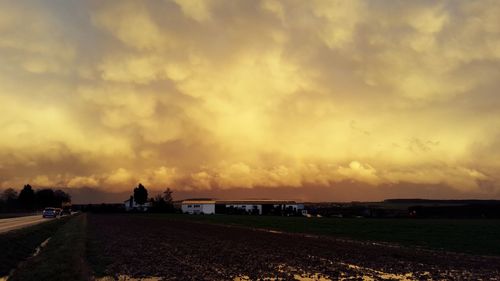 Scenic view of landscape against cloudy sky