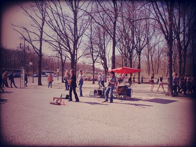 large group of people, tree, men, person, lifestyles, leisure activity, mixed age range, enjoyment, bare tree, fun, crowd, park - man made space, transfer print, togetherness, medium group of people, group of people, auto post production filter, street, outdoors