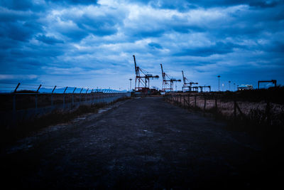 Windmills on landscape against sky