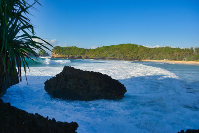 Scenic view of sea against clear blue sky