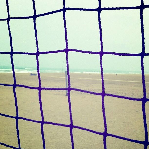 full frame, backgrounds, chainlink fence, pattern, protection, safety, fence, security, metal, metal grate, textured, day, outdoors, close-up, no people, design, beach, focus on foreground, geometric shape, sand