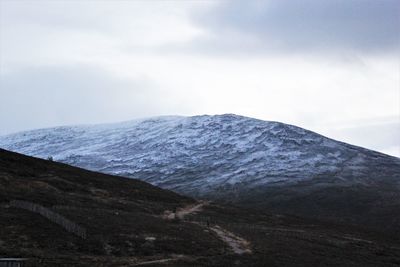 Scenic view of mountain against cloudy sky