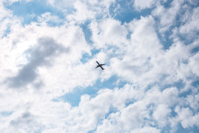 Low angle view of airplane flying in sky