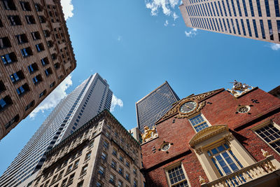 Low angle view of buildings against clear blue sky