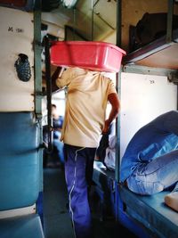 Rear view of man working at bus