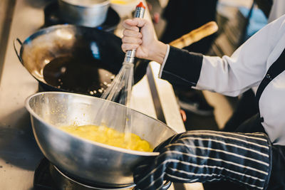 Midsection of man preparing food