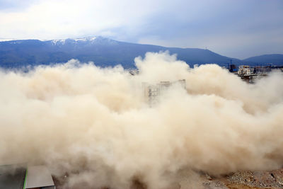 Smoke emitting from volcanic mountain against sky