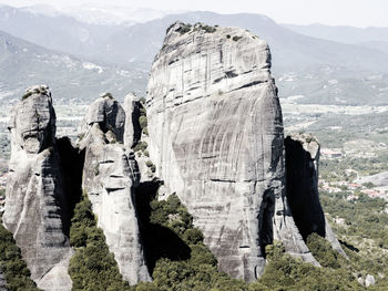 Panoramic view of people on rock against sky