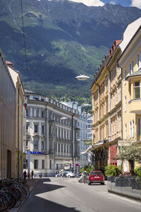 Cars on road by buildings in city