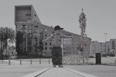 Child with outstretched arms outdoors
