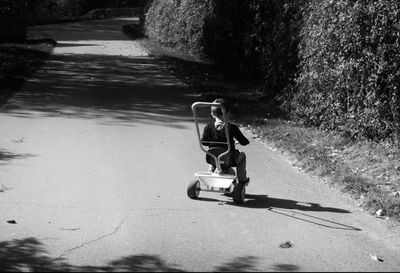 Rear view of woman walking on road