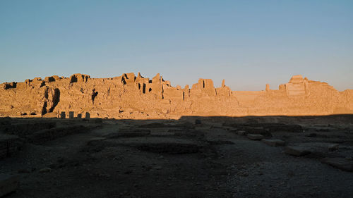 Panoramic view of rock formations against clear blue sky