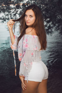 Portrait of beautiful woman standing in park