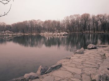 Scenic view of lake against sky during winter