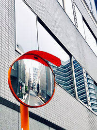 Low angle view of modern glass building in city