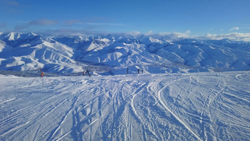 Scenic view of snow covered mountains against sky