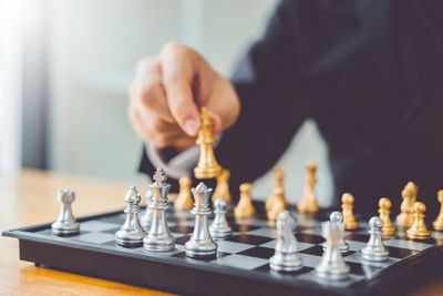 Low angle view of man playing on chess board