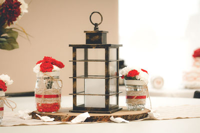 Close-up of old-fashioned lantern and decors on table