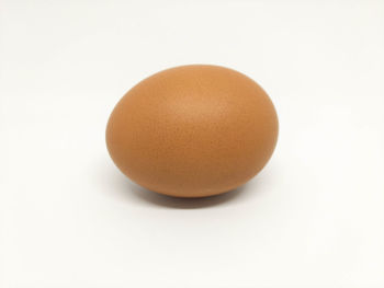 Close-up of egg against white background