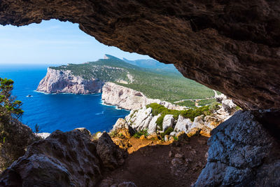 Scenic view of sea seen through cave