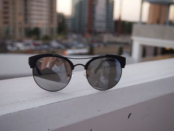 Close-up of sunglasses on mirror