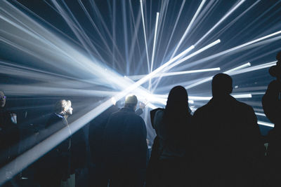 Rear view of people enjoying at music concert