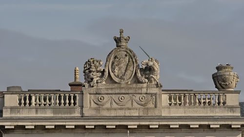 Statue of liberty against sky in city