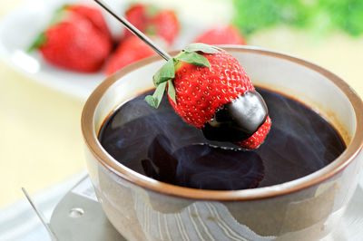 High angle view of strawberries in bowl on table