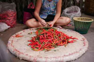 Low section of vendor with red chili pepper at market