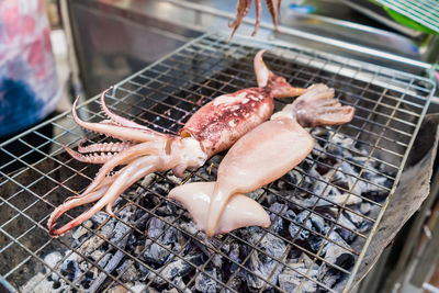 High angle view of meat on barbecue grill