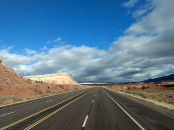 Road amidst landscape against sky