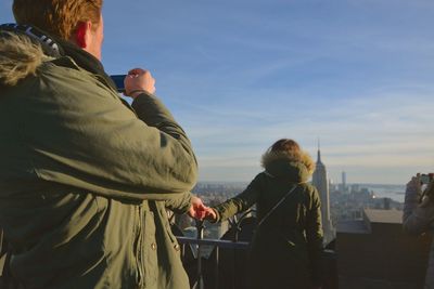 Woman standing in front of cityscape