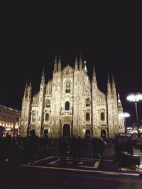 Group of people in front of building at night