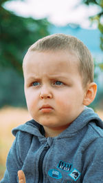 Little boy in hoodie playing outside