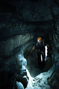 Man with climbing equipment inside a cave