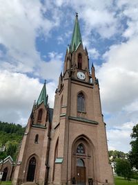 Low angle view of clock tower against sky