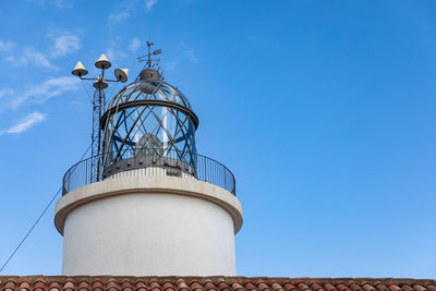 Low angle view of lighthouse against blue sky