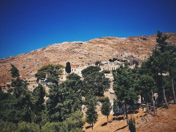 Scenic view of mountains against clear blue sky